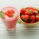 red strawberries in pink plastic cup