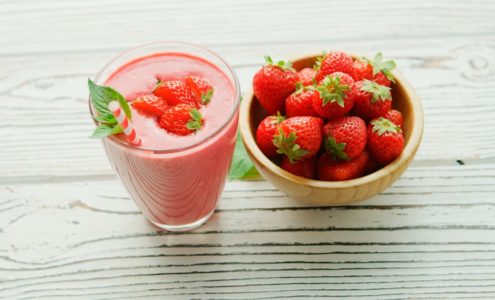 red strawberries in pink plastic cup