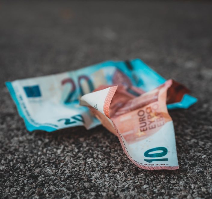 10 and 20 banknotes on concrete surface